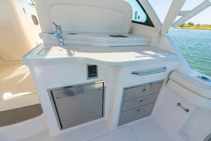 Slide: The Image of 2019 Grady-White Freedom 375 boat interior with kitchenette and storage drawers. - 16