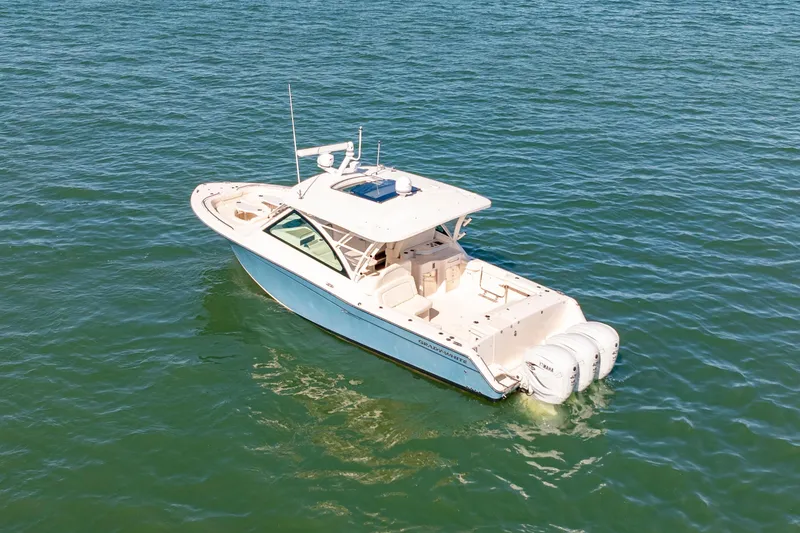Slide: The Image of 2019 Grady-White Freedom 375 boat on open water, aerial view. - 2