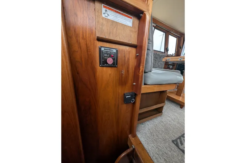 Slide: The Image of 1984 Californian 38 interior with wood paneling and Maxwell anchor winch control. - 12