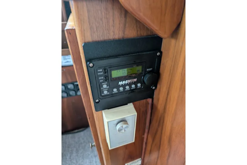 Slide: The Image of Control panel inside 1984 Californian 38 boat, featuring Magnum inverter display. - 13