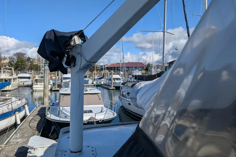 Slide: The Image of Marina view with 1984 Californian 38 yacht, surrounded by boats under a clear blue sky. - 20