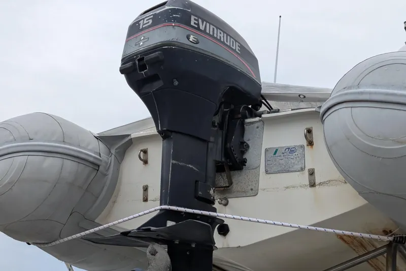 Slide: The Image of Outboard motor on 1984 Californian 38 boat with inflatable dinghy. - 21