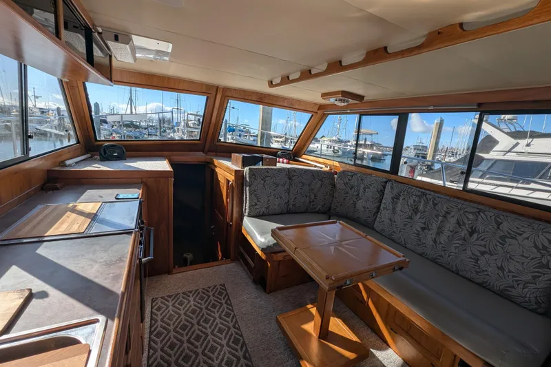 Slide: The Image of Interior of a 1984 Californian 38 yacht with seating and marina view. - 4