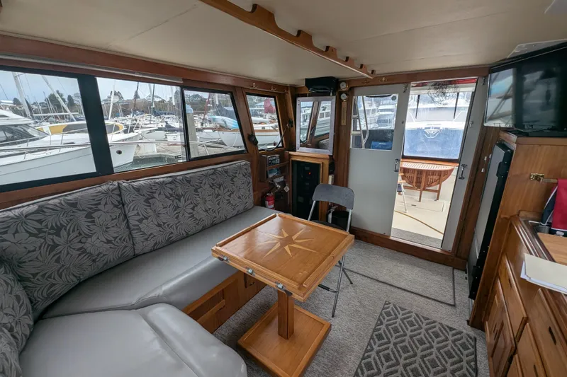Slide: The Image of Interior of a 1984 Californian 38 yacht with cozy seating and wooden accents. - 8