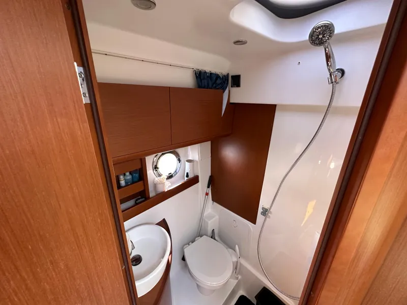 Slide: The Image of Bathroom interior of 2013 Beneteau Gran Turismo 38 yacht, featuring shower, sink, and toilet. - 16