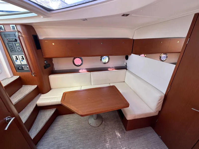 Slide: The Image of Interior of 2013 Beneteau Gran Turismo 38 with cozy seating and wooden table. - 23