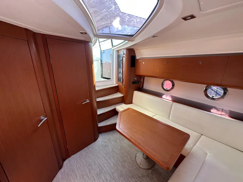 Slide: The Image of Interior of 2013 Beneteau Gran Turismo 38 yacht with wood finish and seating area. - 24