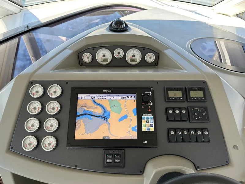 Slide: The Image of Control panel of a 2013 Beneteau Gran Turismo 38 with navigation display and gauges. - 8