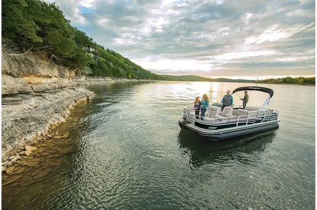 Slide: The Image of Ranger 223FC 2022 pontoon boat on serene lake at sunset. - 5