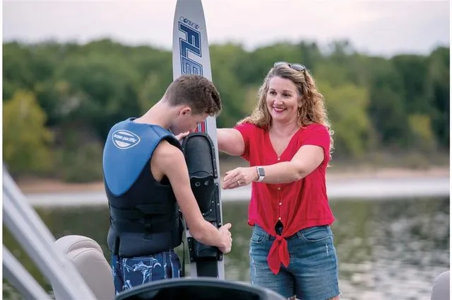 Slide: The Image of Woman assists boy with waterskiing on Ranger 223FC boat, 2022. - 7