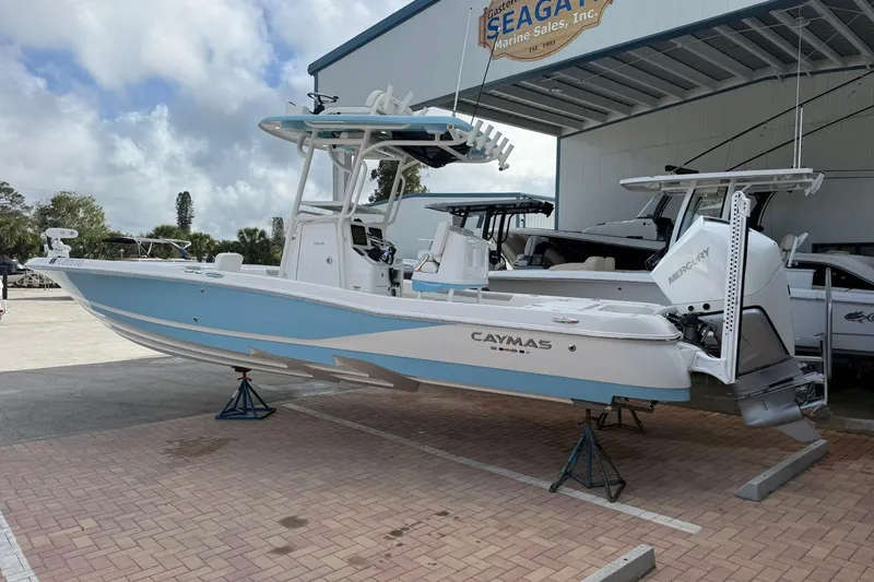Slide: The Image of 2022 Caymas 28 HB Twin boat displayed at a marine sales facility. - 1