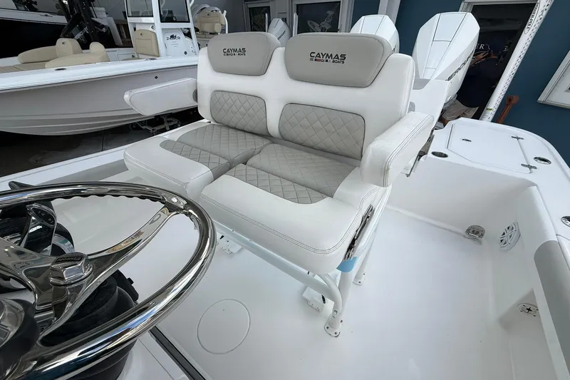 Slide: The Image of 2022 Caymas 28 HB Twin boat interior with cushioned seating and steering wheel. - 11