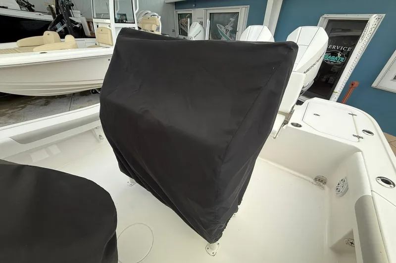 Slide: The Image of 2022 Caymas 28 HB Twin boat interior with covered console and twin engines. - 12