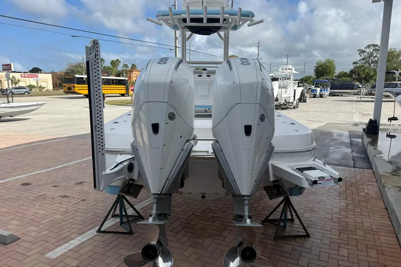 Slide: The Image of 2022 Caymas 28 HB Twin boat with dual outboard engines on display. - 2
