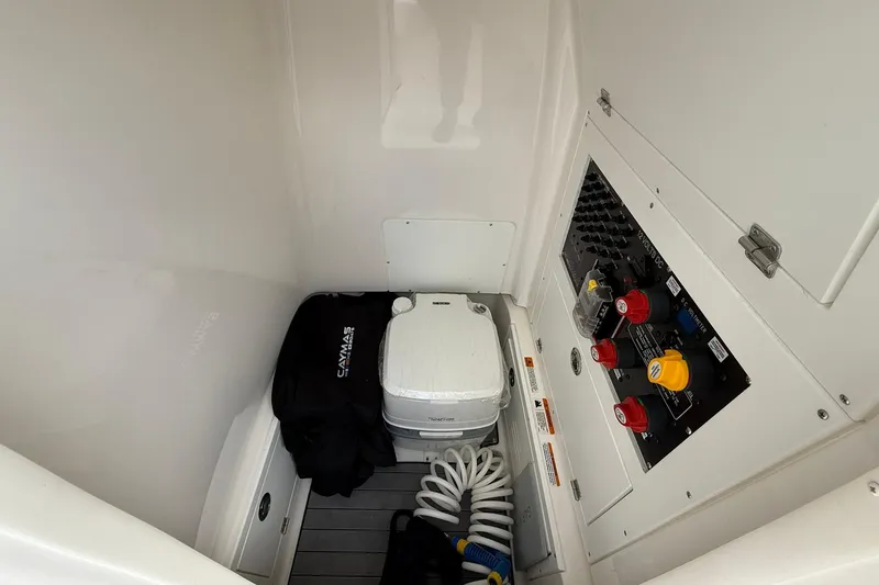 Slide: The Image of 2022 Caymas 28 HB Twin boat interior with control panel and portable toilet. - 22