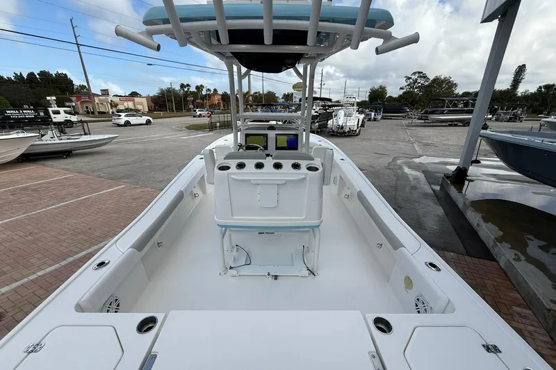 Slide: The Image of 2022 Caymas 28 HB Twin boat, spacious deck, parked at marina under cloudy sky. - 5