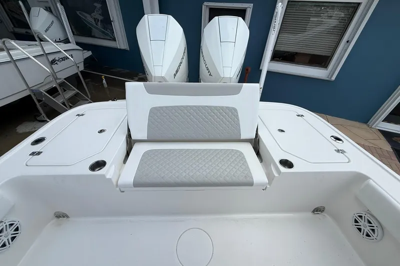 Slide: The Image of 2022 Caymas 28 HB Twin boat with dual Mercury engines and cushioned seating. - 6