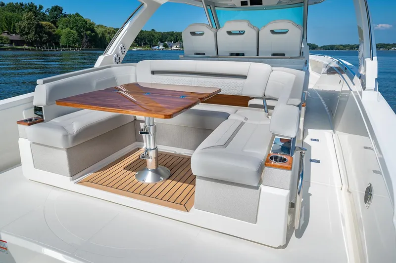 Slide: The Image of Manufacturer Provided Image: 2025 Tiara Yachts 38 LS luxury boat with elegant seating and wooden table on deck. - 18