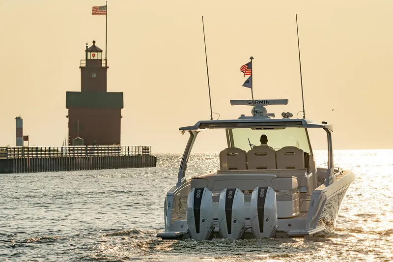 Slide: The Image of Manufacturer Provided Image: 2025 Tiara Yachts 38 LS cruising near a lighthouse at sunset. - 8