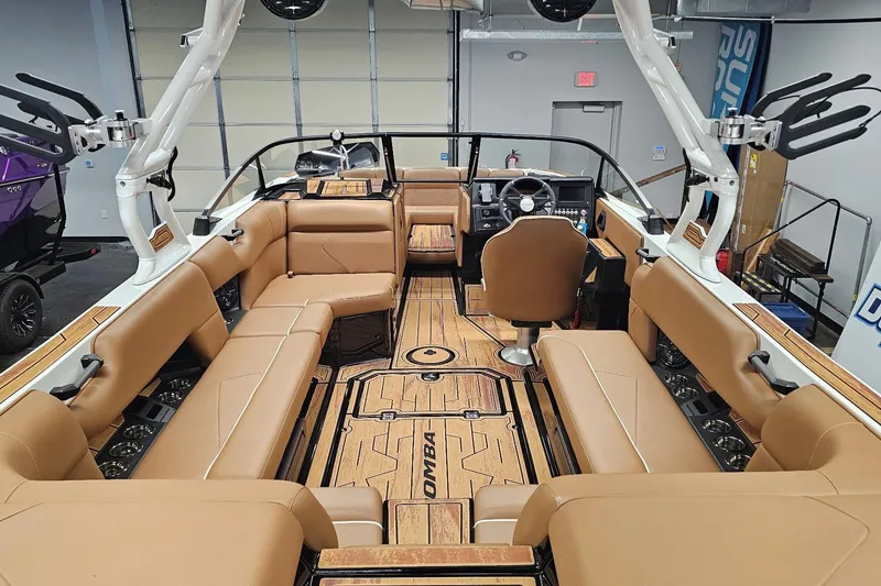 Slide: The Image of 2026 Moomba Tykon boat interior with tan seating and modern dashboard. - 10