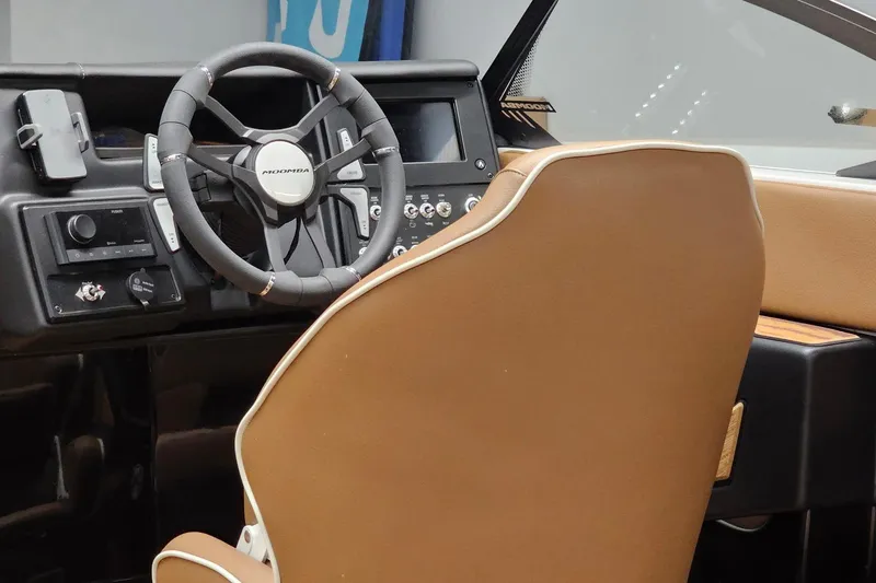 Slide: The Image of Interior of 2026 Moomba Tykon boat featuring steering wheel and control panel. - 15