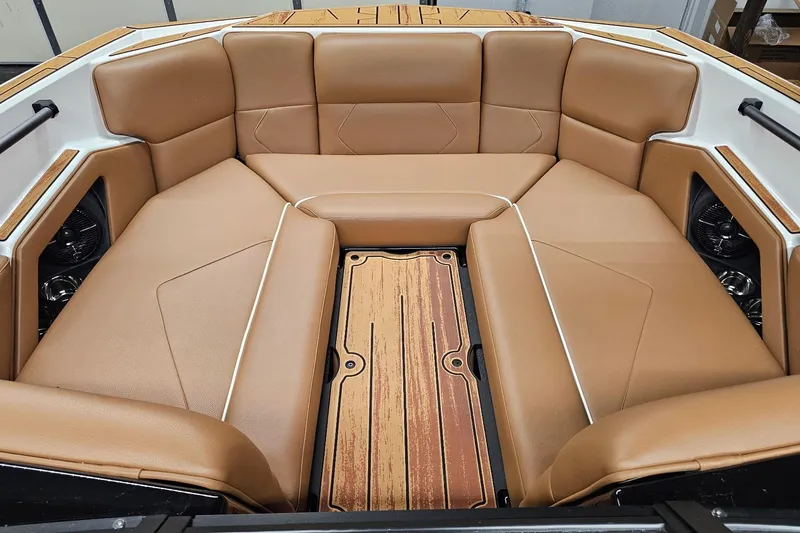 Slide: The Image of 2026 Moomba Tykon boat interior with tan leather seating and wood accents. - 16