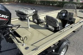 Slide: The Image of 2026 Tracker Grizzly 1754 SC boat with camo seats and Mercury engine. - 12
