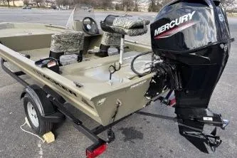 Slide: The Image of 2026 Tracker Grizzly 1754 SC boat with Mercury outboard motor on trailer. - 7