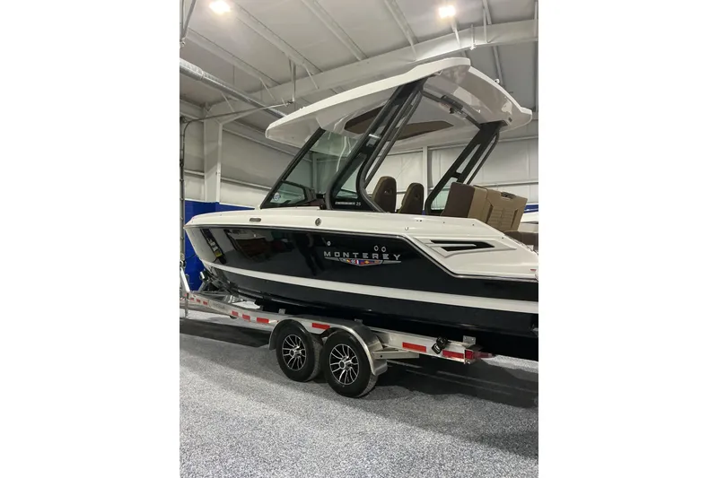 The Image of 2026 Monterey Elite 25 SD boat on trailer in indoor showroom. - 1