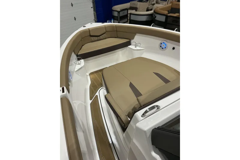 Slide: The Image of 2026 Monterey Elite 25 SD boat interior with tan seating and cup holders. - 10