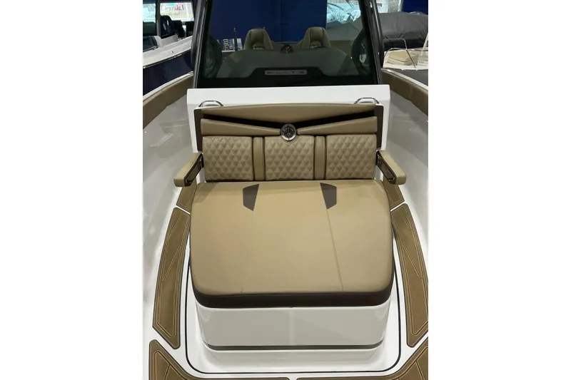 Slide: The Image of 2026 Monterey Elite 25 SD boat interior with tan cushioned seating. - 11