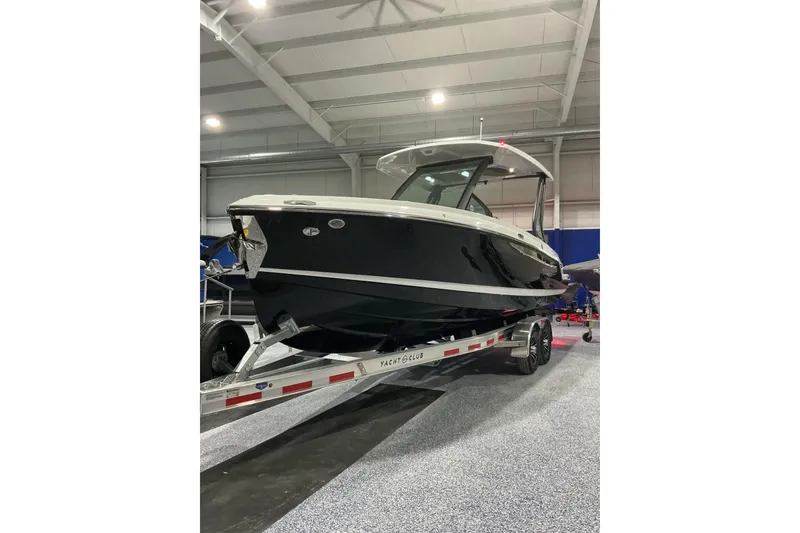 Slide: The Image of 2026 Monterey Elite 25 SD boat on trailer in indoor showroom. - 3