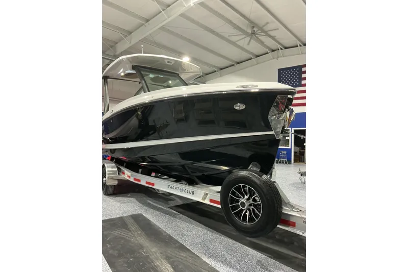 Slide: The Image of 2026 Monterey Elite 25 SD boat on trailer in indoor showroom. - 4