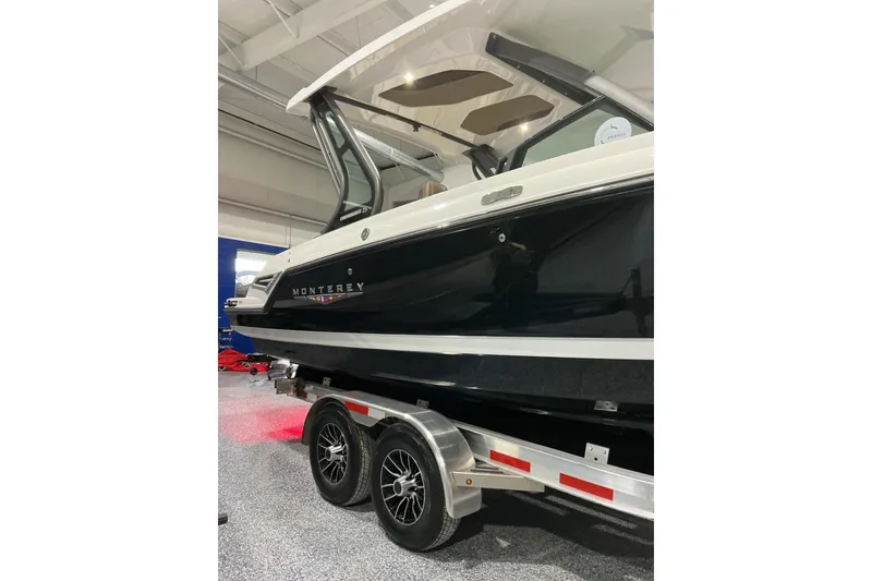Slide: The Image of 2026 Monterey Elite 25 SD boat on trailer in showroom. - 5