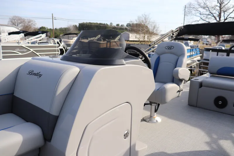 Slide: The Image of 2026 Bentley Pontoons Legacy 223 Swingback interior with steering console and seating. - 4