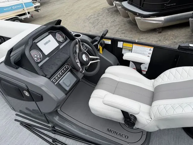 Slide: The Image of 2026 Godfrey Monaco 235 SFL boat cockpit with steering wheel and controls. - 14