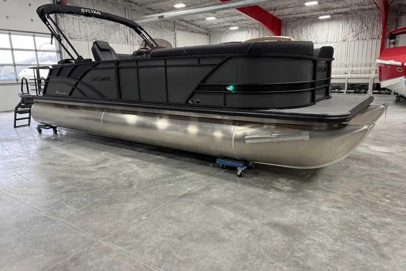 The Image of 2026 Sylvan X5 pontoon boat in showroom, featuring sleek black design and modern amenities. - 1