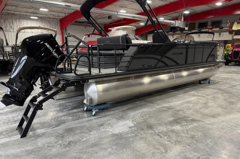 Slide: The Image of 2026 Sylvan X5 pontoon boat in showroom, featuring sleek design and powerful Mercury engine. - 3
