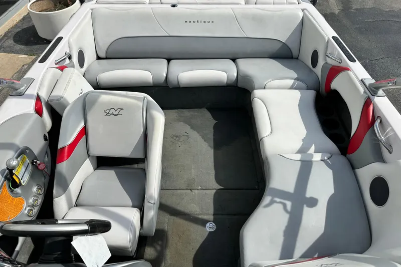 Slide: The Image of 2004 Nautique Air Nautique 226 boat interior with gray and red seating arrangement. - 10