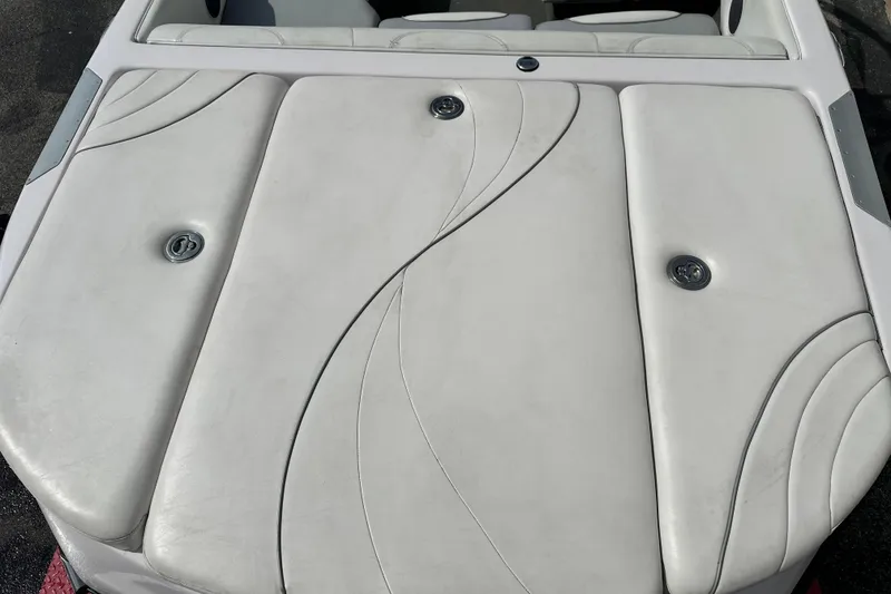 Slide: The Image of 2004 Nautique Air Nautique 226 boat interior with sleek white upholstery design. - 4