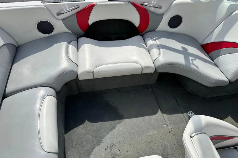 Slide: The Image of 2004 Nautique Air Nautique 226 boat interior with gray and red seating. - 6
