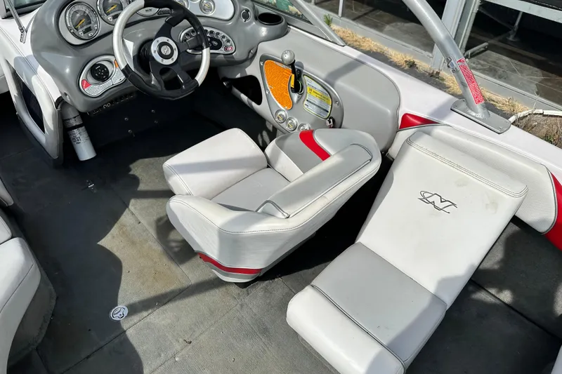 Slide: The Image of 2004 Nautique Air Nautique 226 boat interior with steering wheel and seating. - 7