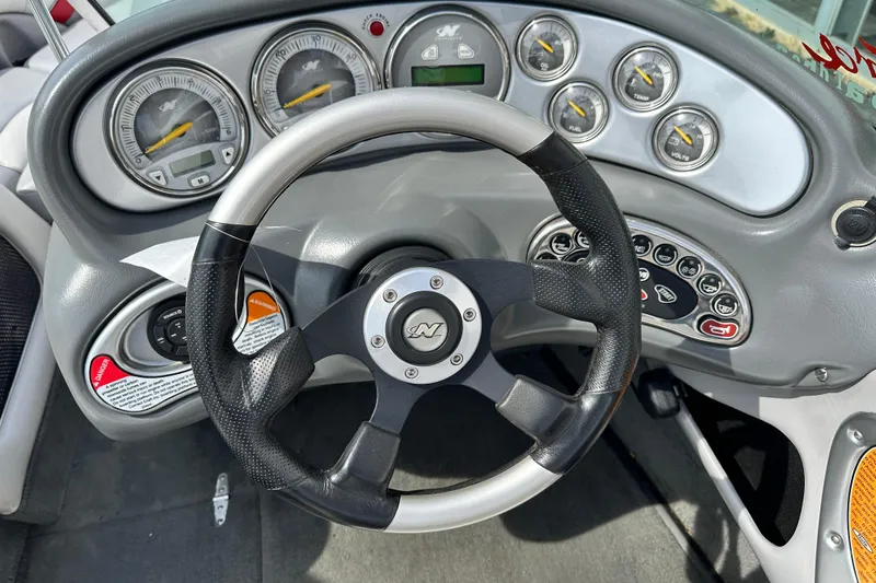 Slide: The Image of 2004 Nautique Air Nautique 226 dashboard with steering wheel and gauges. - 8