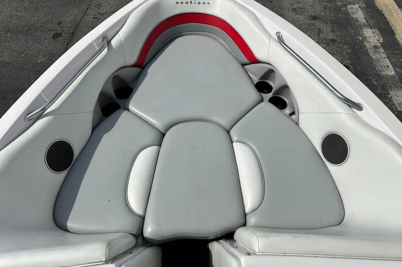 Slide: The Image of 2004 Nautique Air Nautique 226 boat interior with gray seating and cup holders. - 9