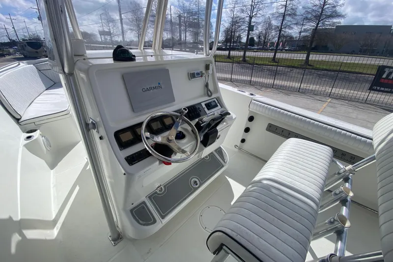 Slide: The Image of 2006 Sailfish 2360 CC boat cockpit with Garmin navigation system and seating. - 10