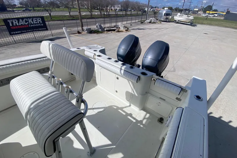 Slide: The Image of 2006 Sailfish 2360 CC boat interior with dual outboard motors and seating. - 11