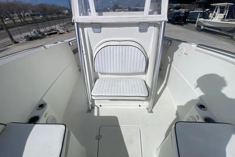 Slide: The Image of 2006 Sailfish 2360 CC boat interior with white seating and console. - 15