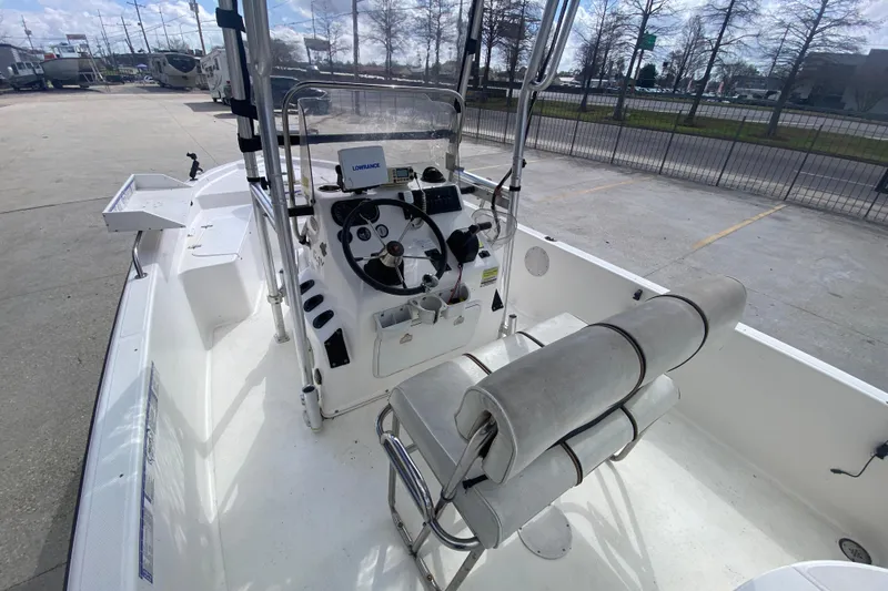 Slide: The Image of 2006 Sailfish 2360 CC boat interior with steering console and seating. - 17