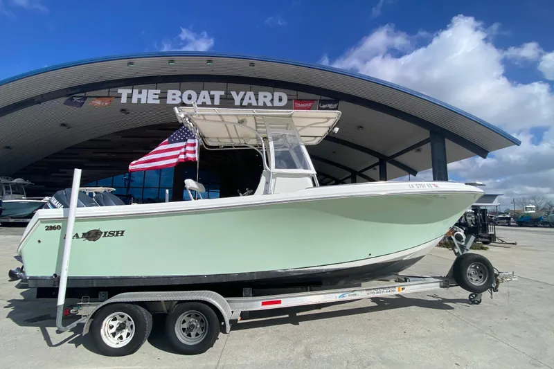 Slide: The Image of 2006 Sailfish 2360 CC boat on trailer at The Boat Yard, American flag displayed. - 2