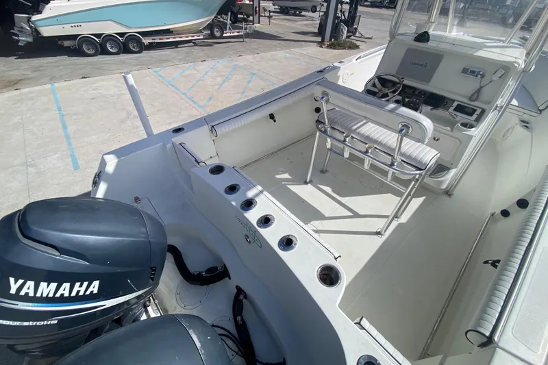 Slide: The Image of 2006 Sailfish 2360 CC boat interior with Yamaha outboard motor, docked at marina. - 20